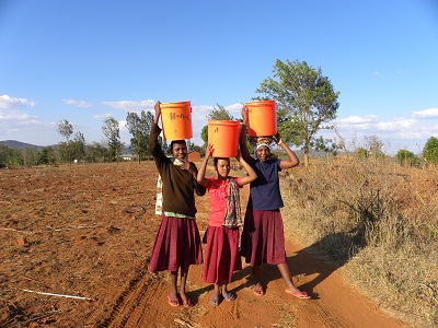 3 girls with buckets on heads